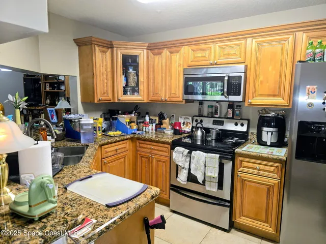a kitchen with a stove a sink and a refrigerator