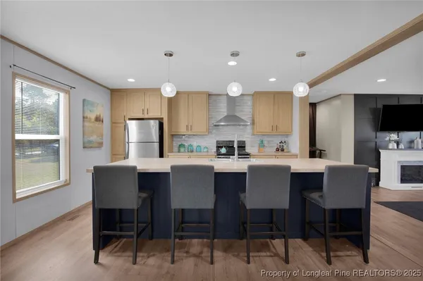 a kitchen with a dining table chairs and refrigerator
