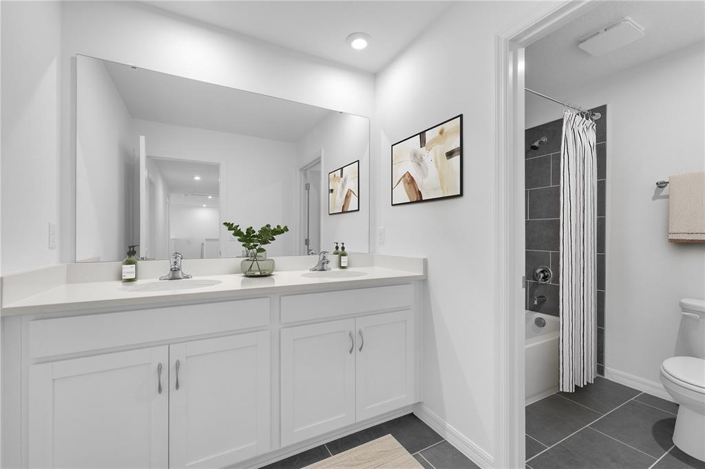 1873 Shadow Box Bend St. Cloud, FL 34771 - Photo 21 of 27 a bathroom with a toilet sink and mirror