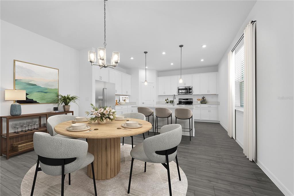 1873 Shadow Box Bend St. Cloud, FL 34771 - Photo 3 of 27 a view of a dining room with furniture and wooden floor