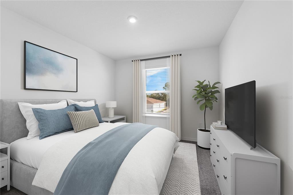 1873 Shadow Box Bend St. Cloud, FL 34771 - Photo 8 of 27 a bedroom with a bed and a flat screen tv