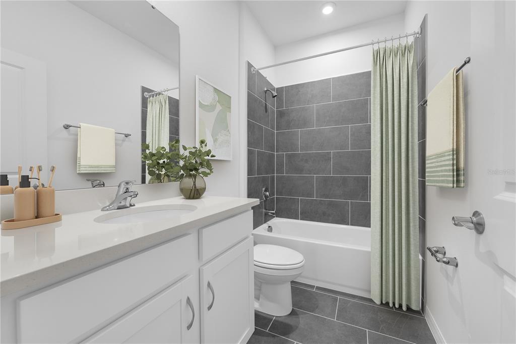 1873 Shadow Box Bend St. Cloud, FL 34771 - Photo 10 of 27 a bathroom with a sink a toilet and shower