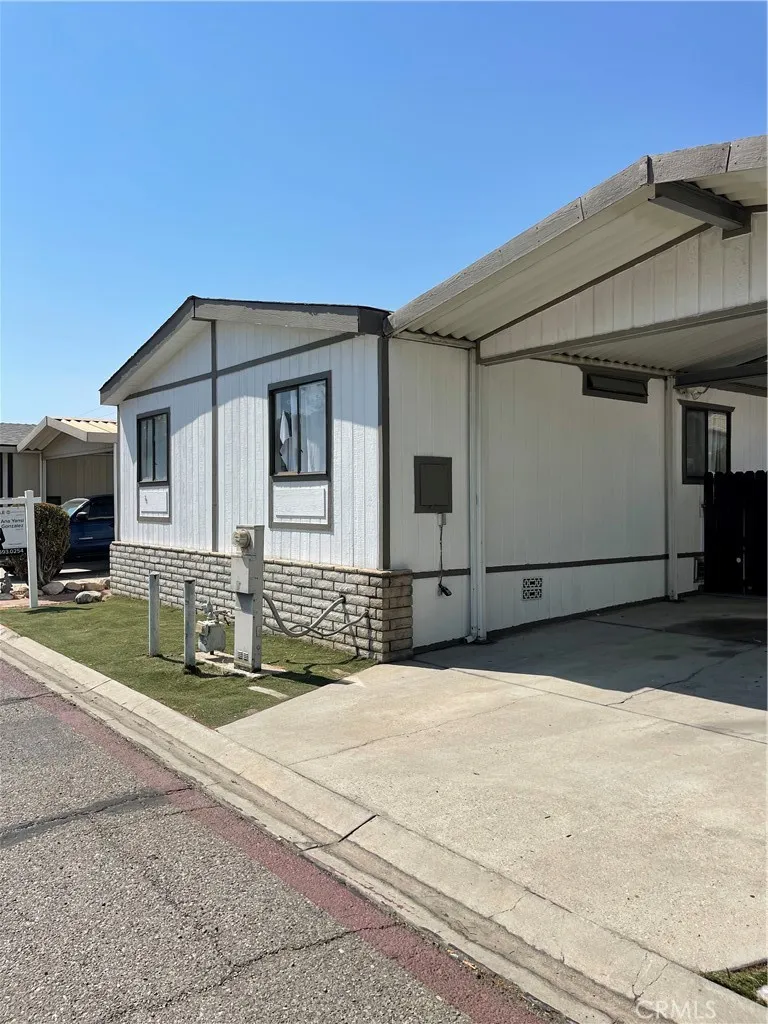 7717 Church Street, Unit 54 Highland, CA 92346 - Photo 2 of 13 a front view of a house with a yard