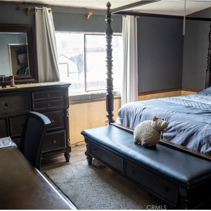 7717 Church Street, Unit 54 Highland, CA 92346 - Photo 6 of 13 a bedroom with a bed and window