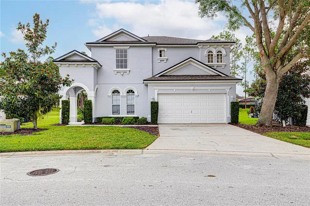 a front view of a house with a yard and garage