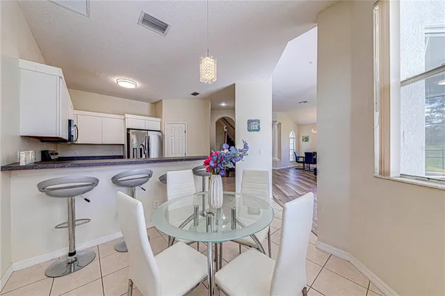 a metallic refrigerator freezer sitting in a kitchen
