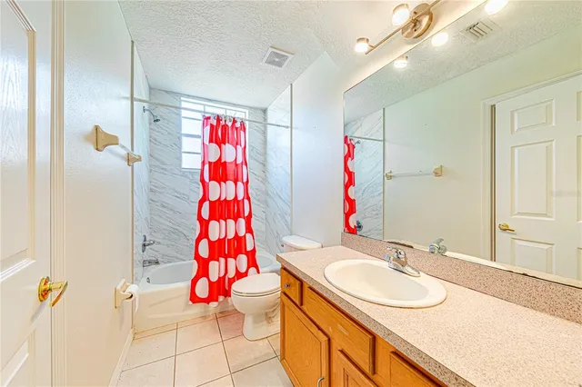 a living room with furniture a floor to ceiling window and potted plants