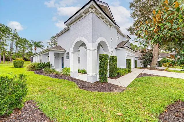 a front view of a house with yard and green space