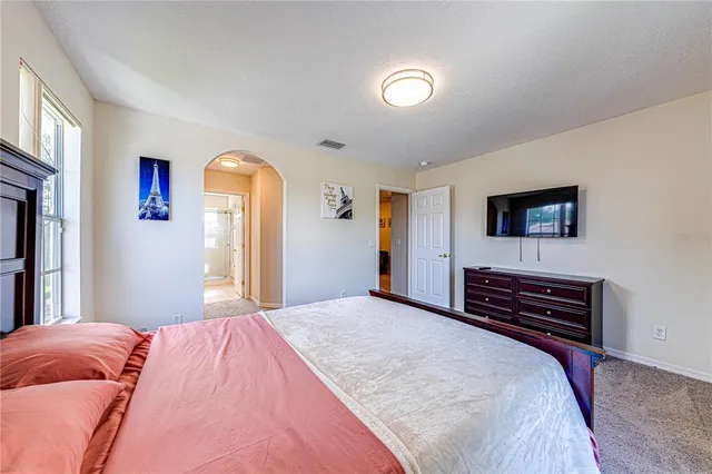 a bedroom with a bed and a lamp