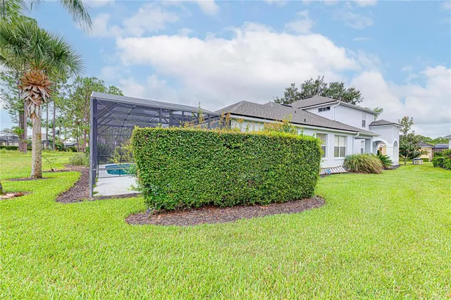 a view of a garden with a house in the background