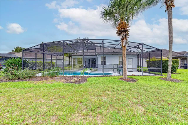 a house view with swimming pool and garden space