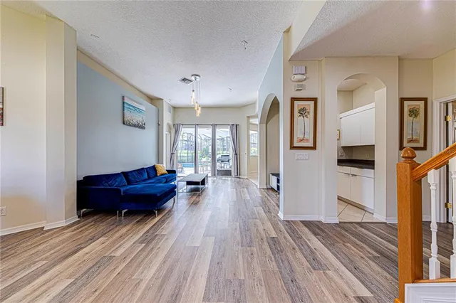 a living room with furniture a flat screen tv and a large window