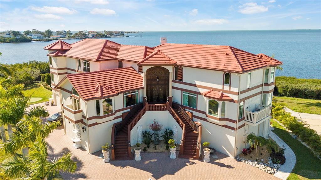 an aerial view of a house with swimming pool and ocean view