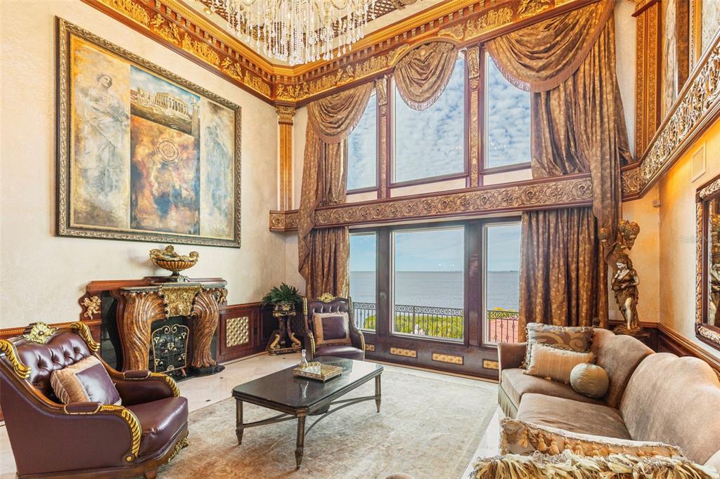 2115 Alexis Court Tarpon Springs, FL 34689 - Photo 15 of 100 a living room with furniture a floor to ceiling window and a rug