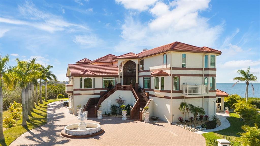 2115 Alexis Court Tarpon Springs, FL 34689 - Photo 2 of 100 a front view of a house with a yard