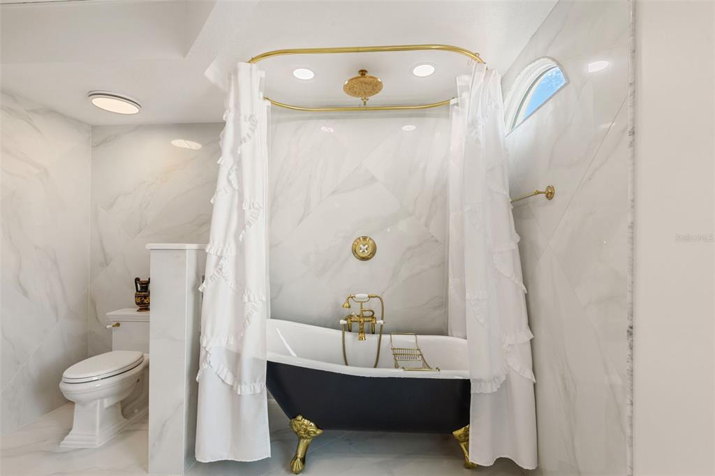 2115 Alexis Court Tarpon Springs, FL 34689 - Photo 34 of 100 a bathroom with a sink a toilet and shower