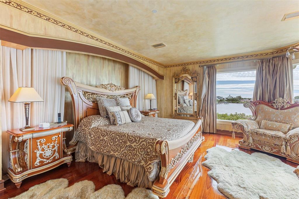 2115 Alexis Court Tarpon Springs, FL 34689 - Photo 41 of 100 a bedroom with a bed and a couch