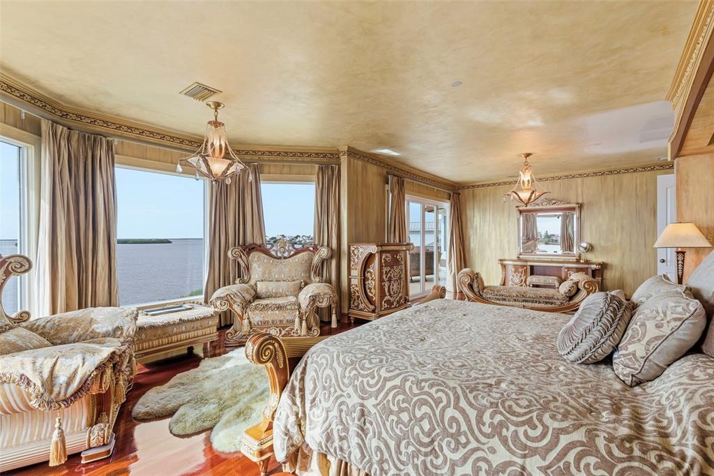 2115 Alexis Court Tarpon Springs, FL 34689 - Photo 42 of 100 a bedroom with two beds and a large mirror next to a window