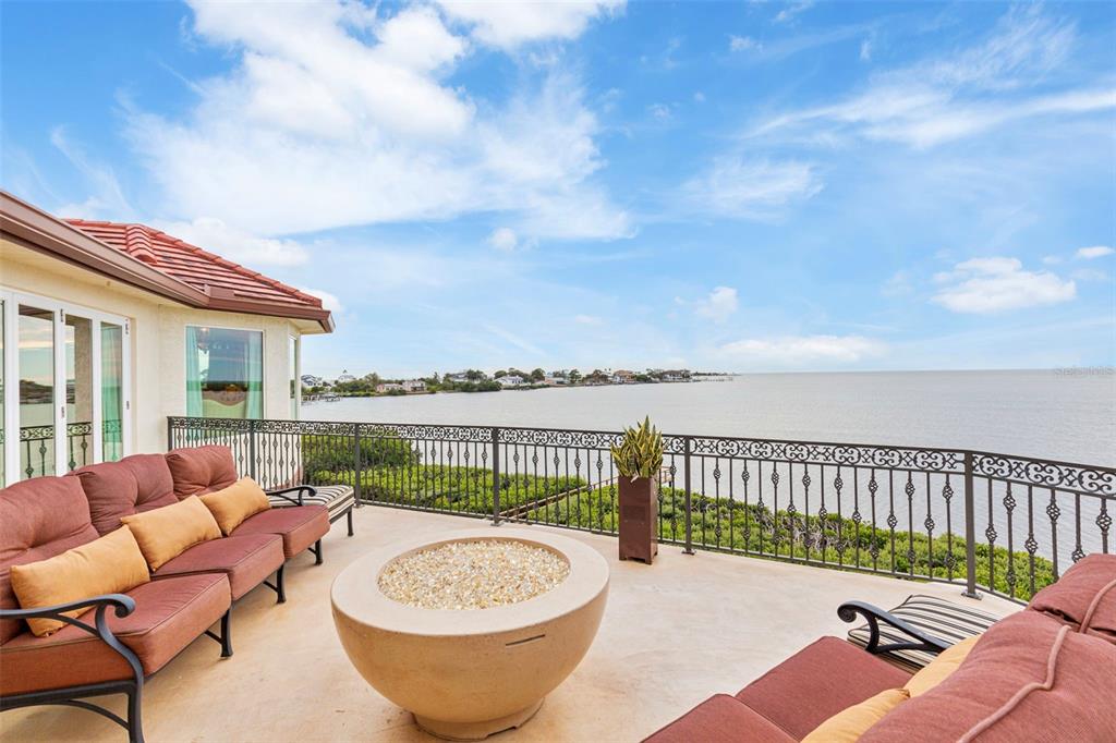 2115 Alexis Court Tarpon Springs, FL 34689 - Photo 47 of 100 a view of a patio with a dining table and chairs with wooden floor