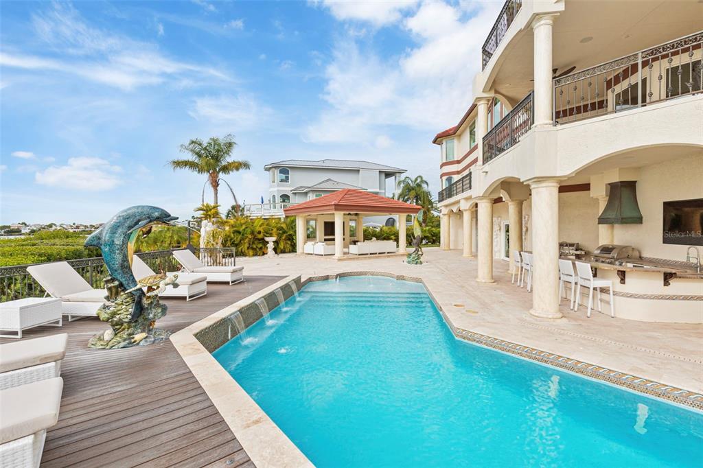 2115 Alexis Court Tarpon Springs, FL 34689 - Photo 55 of 100 a view of a swimming pool with a lounge chair