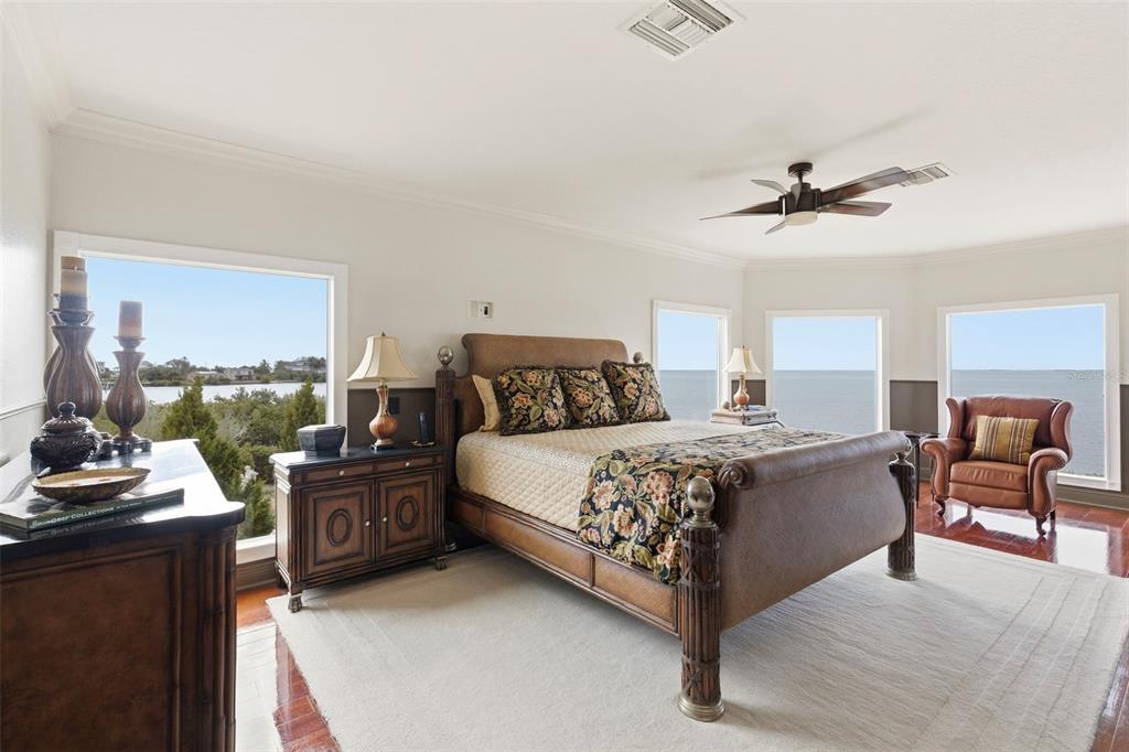 2115 Alexis Court Tarpon Springs, FL 34689 - Photo 66 of 100 a bedroom with a bed couches and a flat tv screen