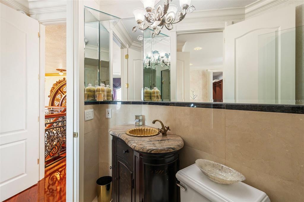 2115 Alexis Court Tarpon Springs, FL 34689 - Photo 75 of 100 a bathroom with a sink a toilet and mirror