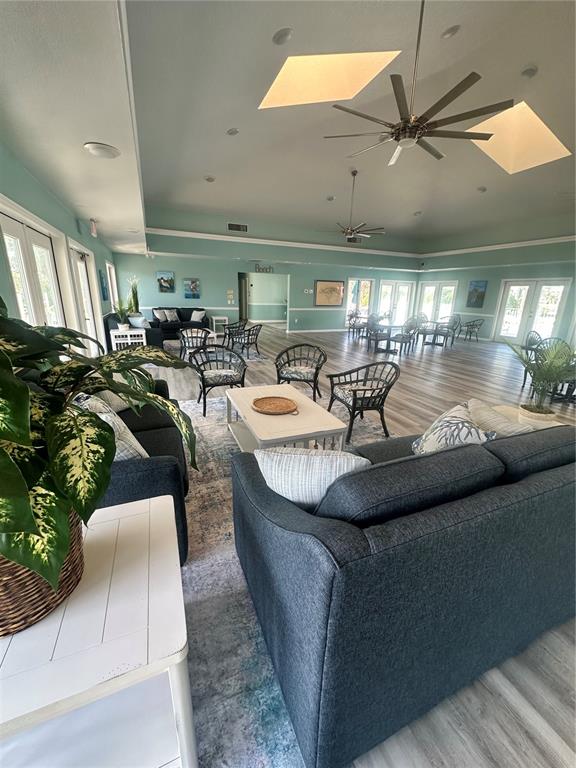 2115 Alexis Court Tarpon Springs, FL 34689 - Photo 96 of 100 a living room with lots of furniture and a chandelier