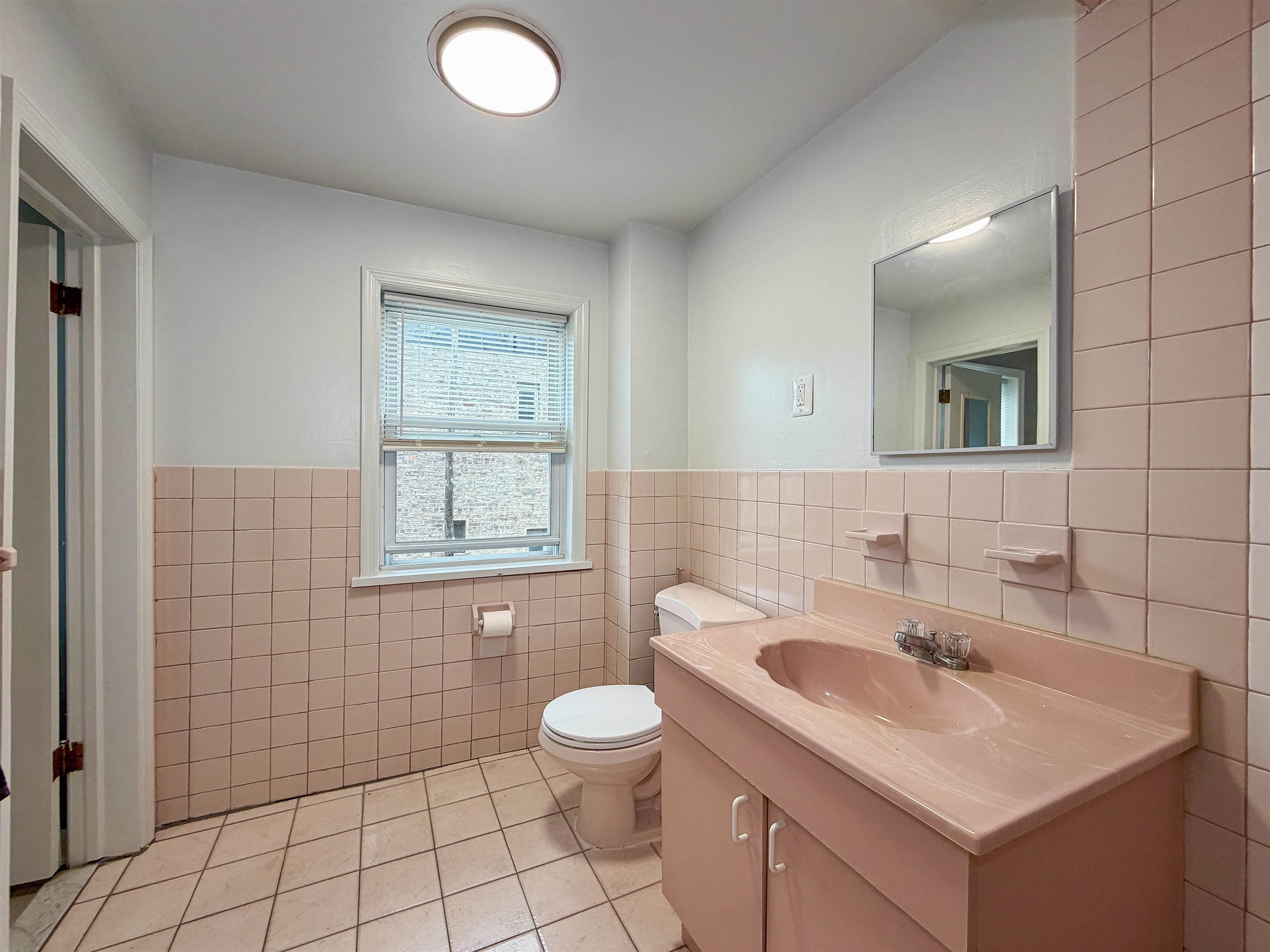 164 6th Street, Unit 2 Hoboken, NJ 07030 - Photo 12 of 12 a bathroom with a sink toilet and shower
