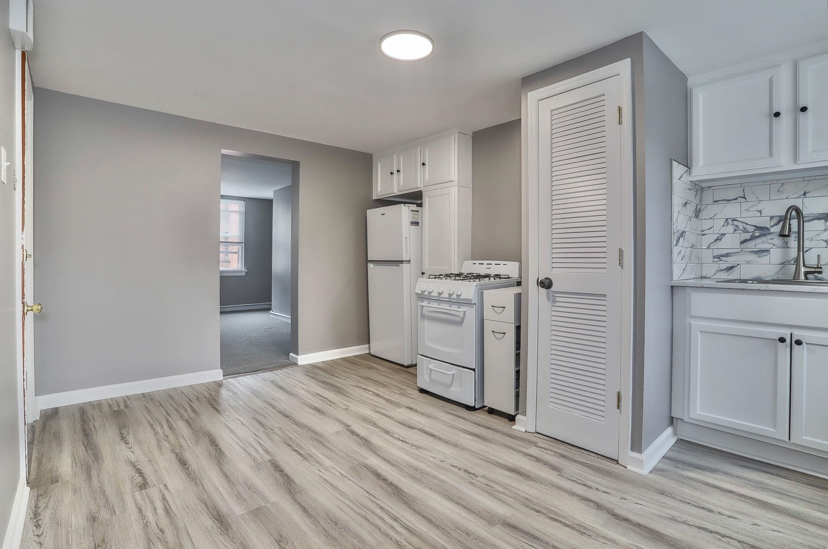 164 6th Street, Unit 2 Hoboken, NJ 07030 - Photo 2 of 12 wooden floor with white cabinets