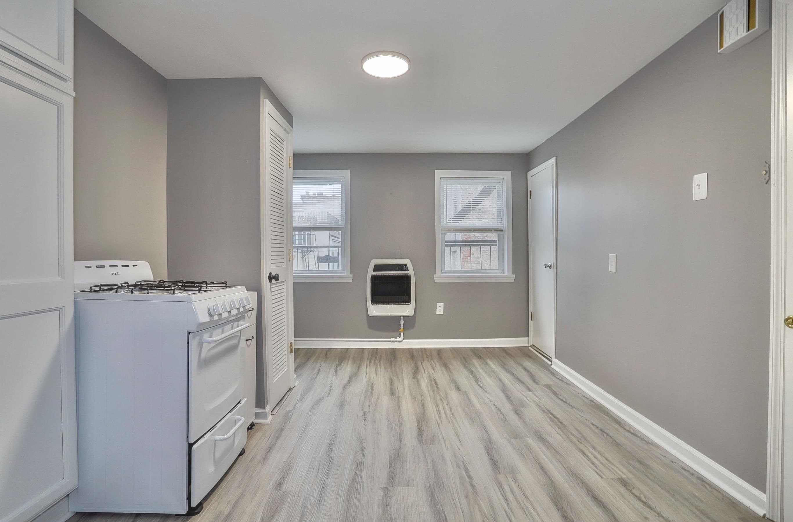 164 6th Street, Unit 2 Hoboken, NJ 07030 - Photo 3 of 12 wooden floor in an empty room with a window