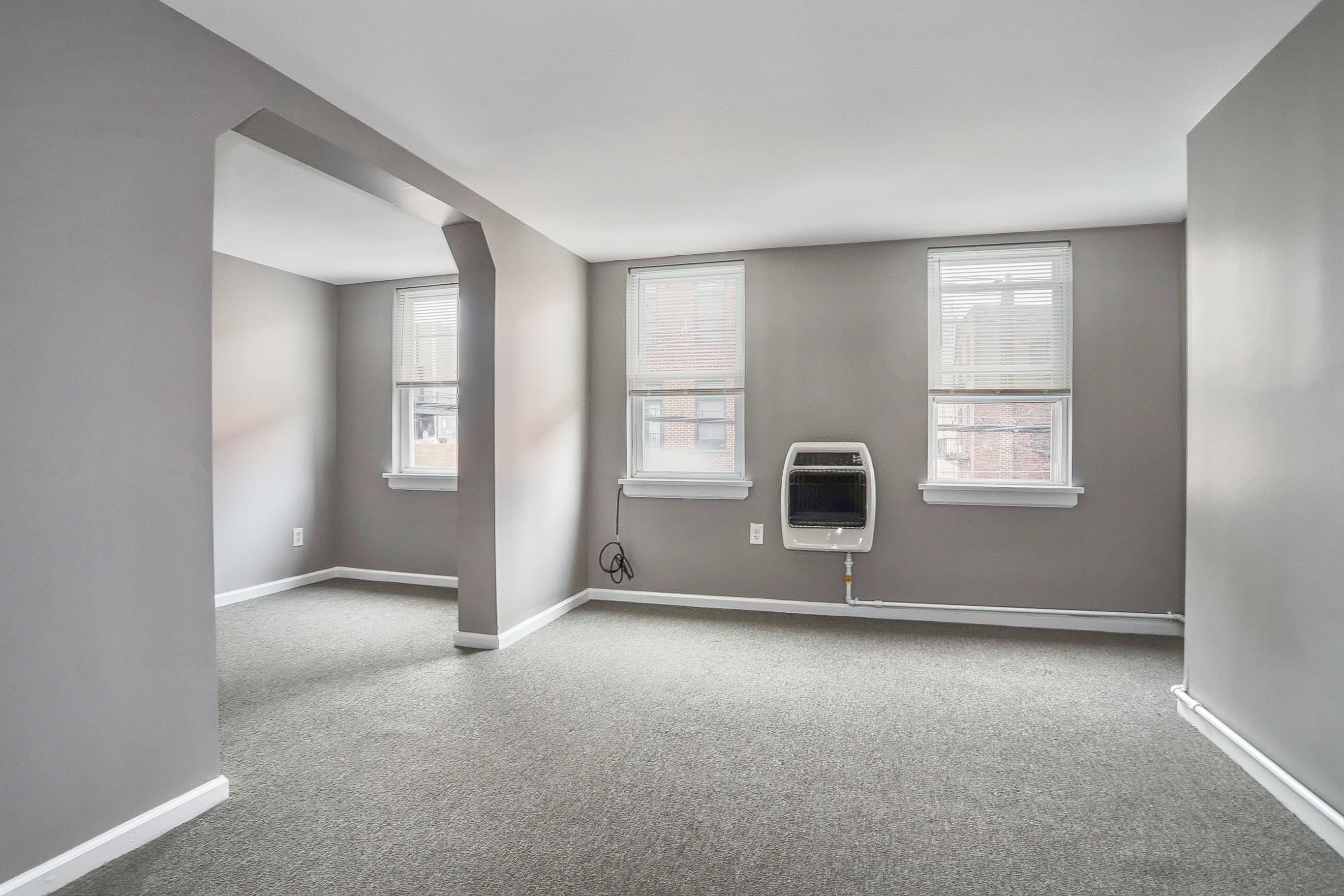 164 6th Street, Unit 2 Hoboken, NJ 07030 - Photo 4 of 12 an empty room with windows and fireplace