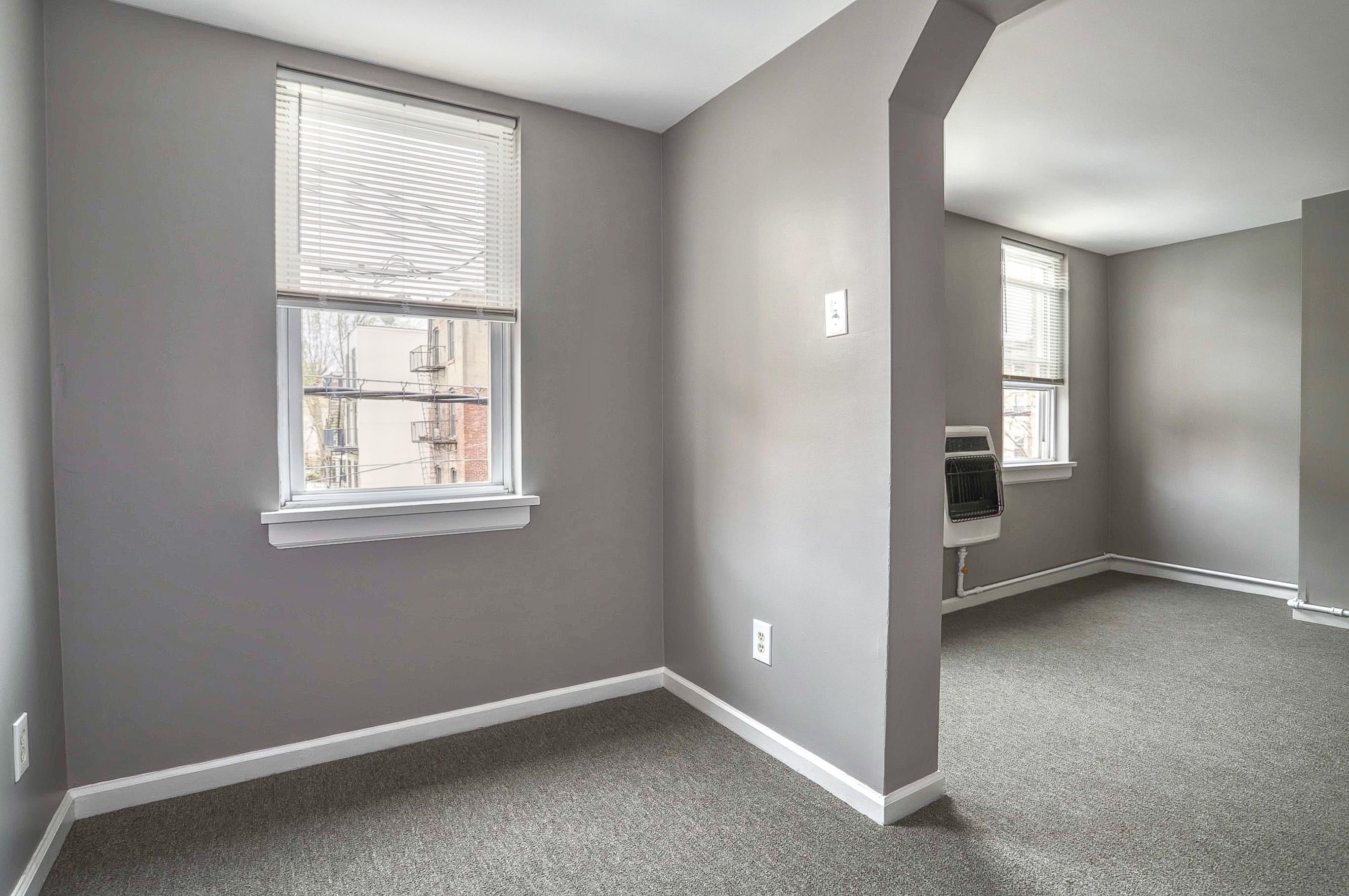 164 6th Street, Unit 2 Hoboken, NJ 07030 - Photo 5 of 12 an empty room with windows and closet