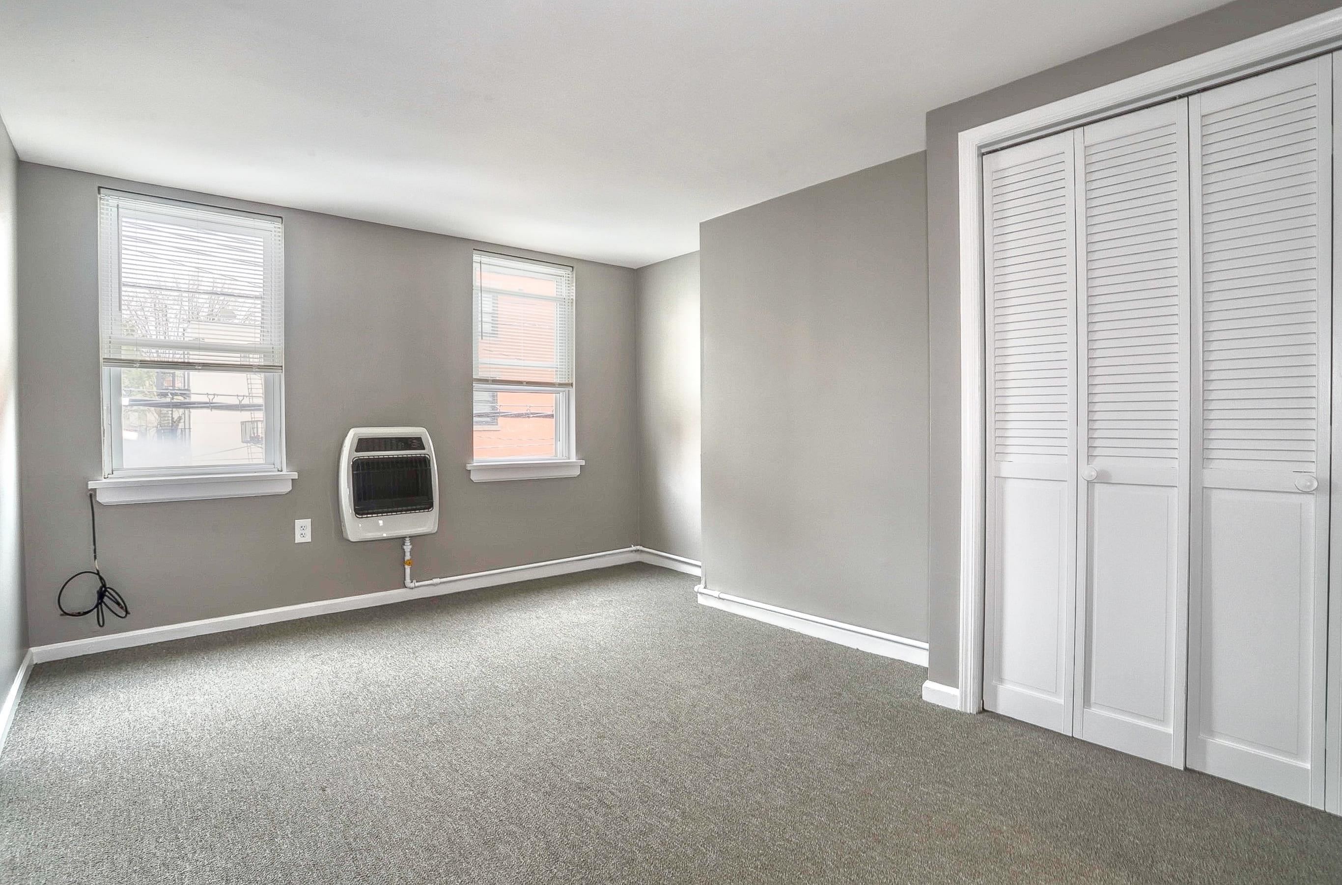 164 6th Street, Unit 2 Hoboken, NJ 07030 - Photo 6 of 12 an empty room with windows