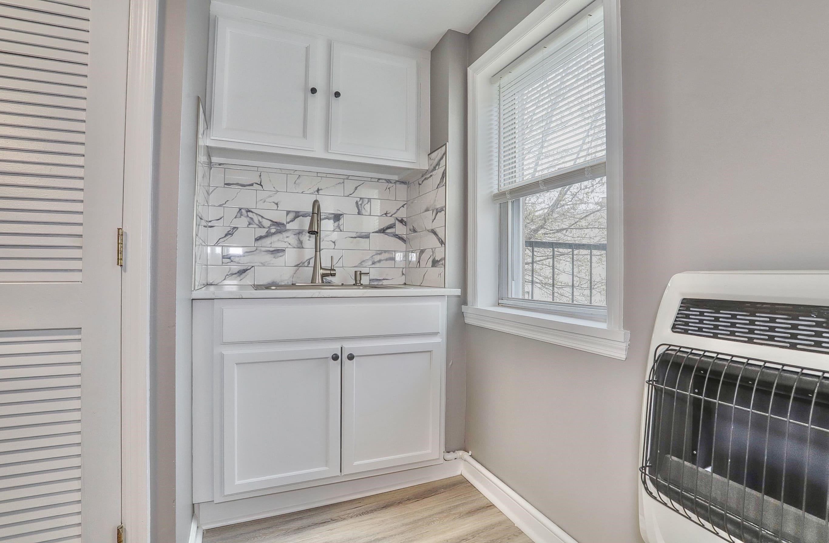 164 6th Street, Unit 2 Hoboken, NJ 07030 - Photo 10 of 12 a view of wooden floor and cabinets in a room