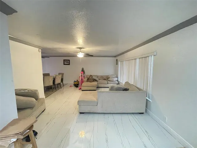 a living room with furniture and a mirror