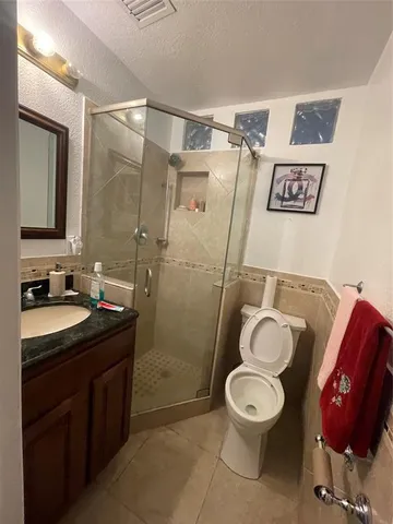 a bathroom with a double vanity sink mirror and toilet