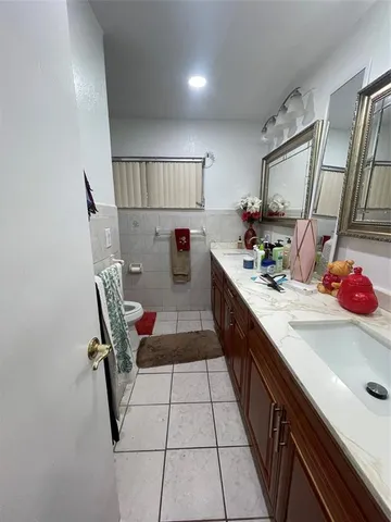 a kitchen with a sink appliances and cabinets
