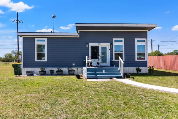 a view of a house with a yard and sitting area
