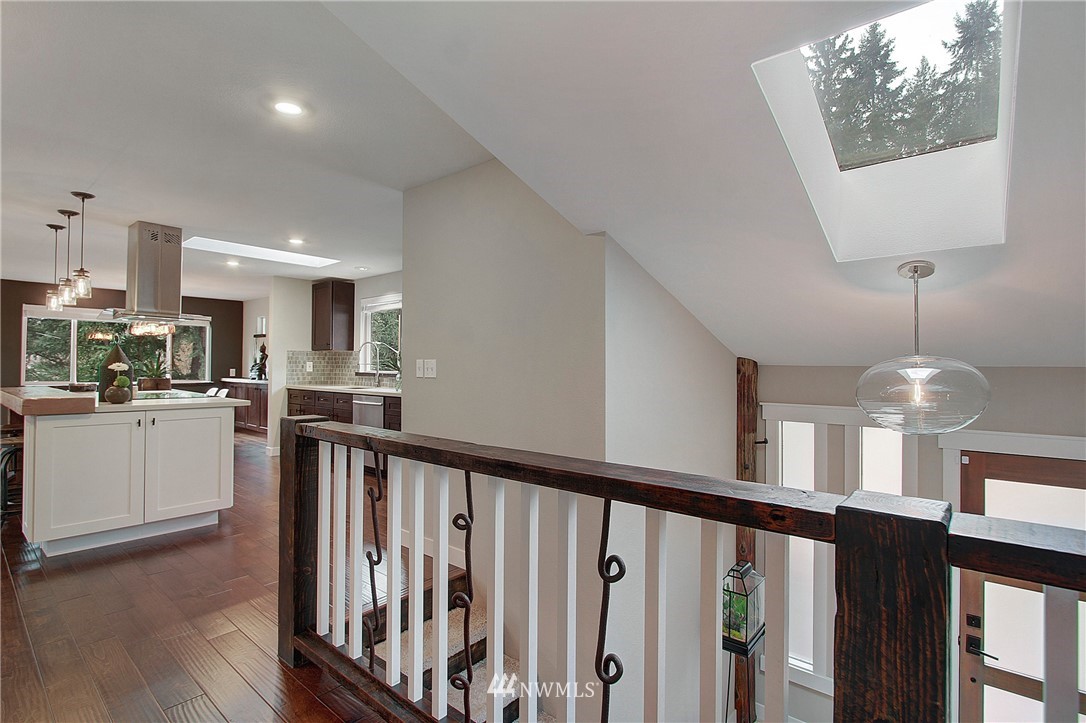 15003 Southeast 138th Place Renton, WA 98059 - Photo 17 of 38 a view of a kitchen with a sink wooden floor and staircase