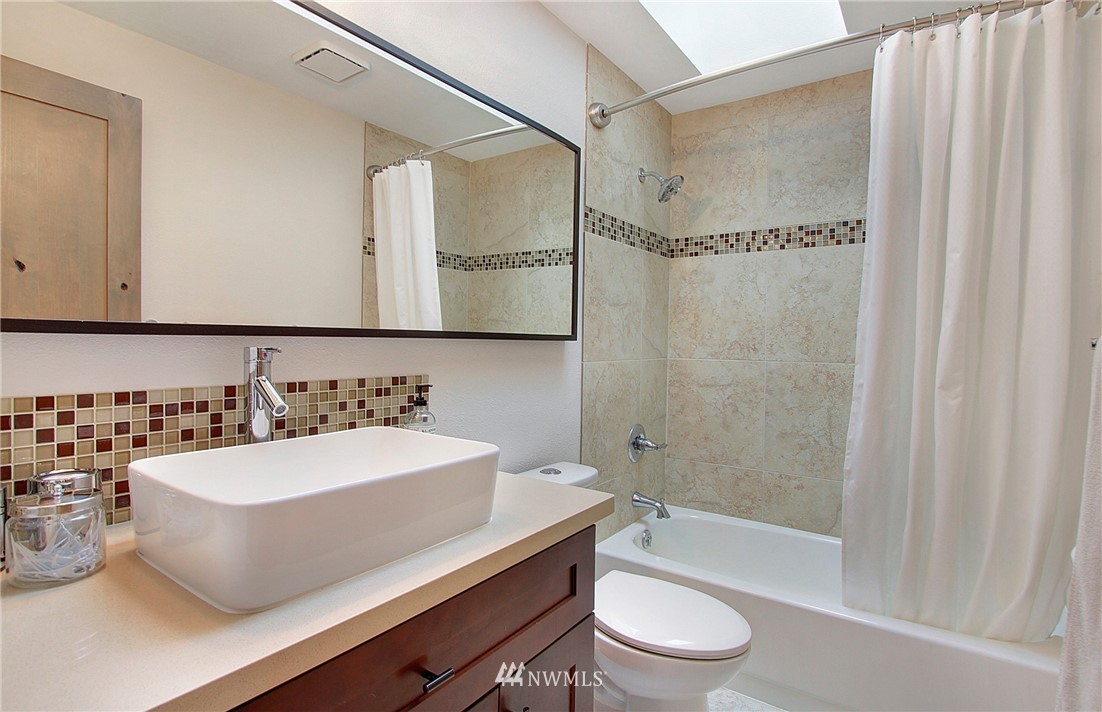 15003 Southeast 138th Place Renton, WA 98059 - Photo 19 of 38 a bathroom with a sink a toilet and shower