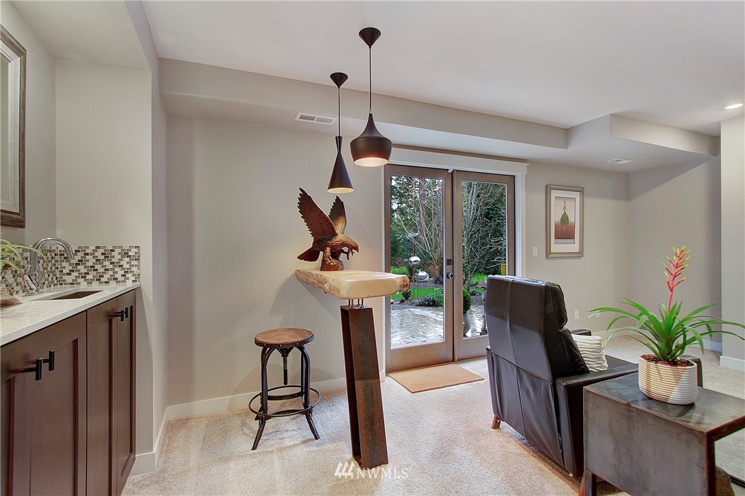 15003 Southeast 138th Place Renton, WA 98059 - Photo 23 of 38 a dining room with furniture a chandelier and wooden floor