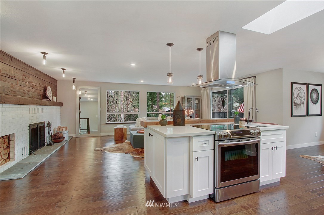15003 Southeast 138th Place Renton, WA 98059 - Photo 7 of 38 a kitchen with a stove top oven and cabinets