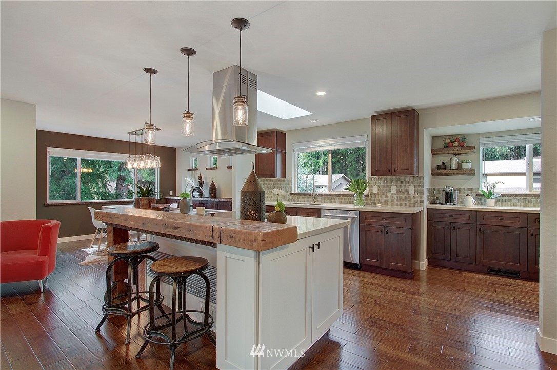 15003 Southeast 138th Place Renton, WA 98059 - Photo 8 of 38 a kitchen with stainless steel appliances kitchen island a large island in the center