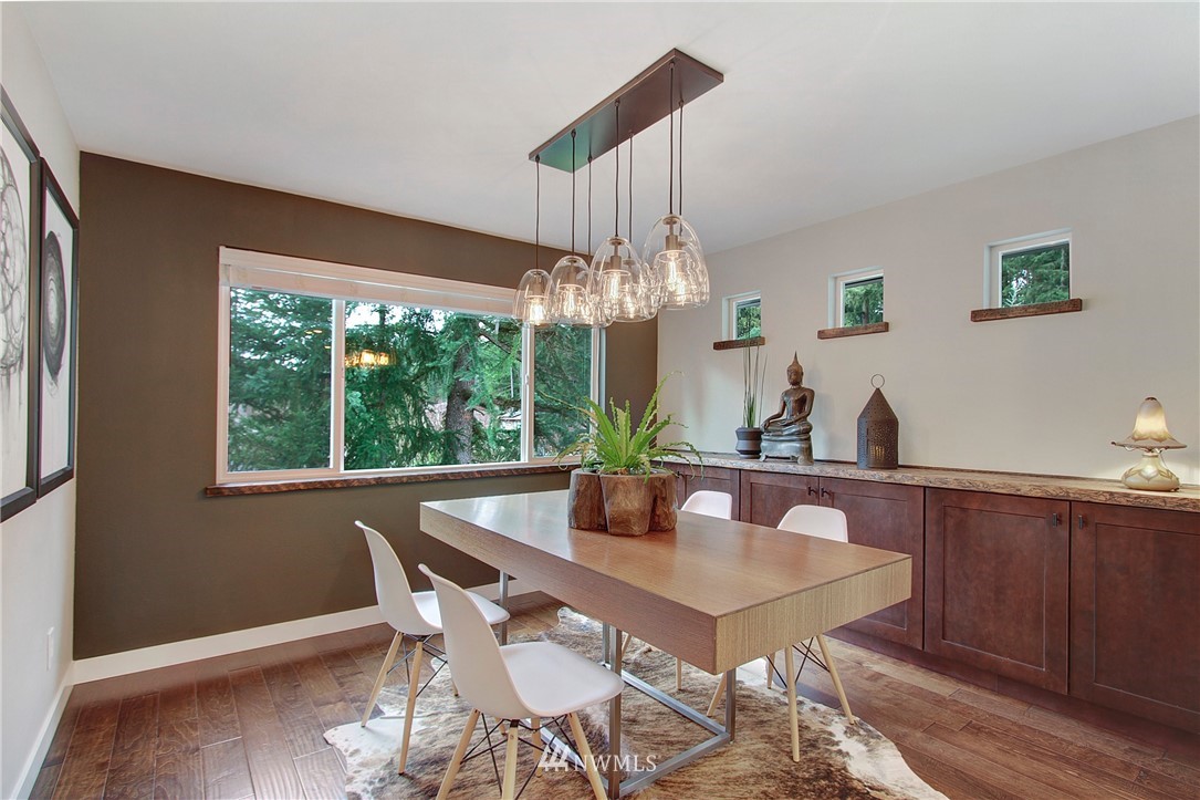 15003 Southeast 138th Place Renton, WA 98059 - Photo 10 of 38 a dining room with furniture a chandelier and wooden floor
