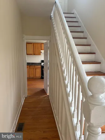 a view of entryway and hall with wooden floor