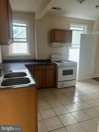 a kitchen that has a sink and a stove top oven