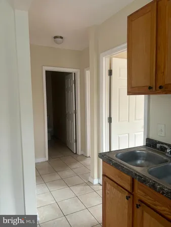 a kitchen with granite countertop a sink and a stove