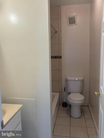 a white toilet sitting next to a white sink