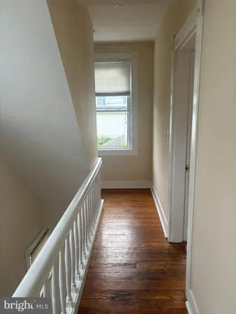 a view of hallway with wooden floor