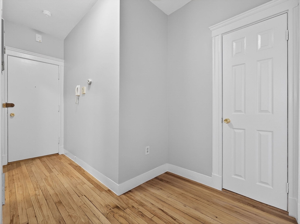 12 Ransom Road, Unit 7 Boston, MA 02135 - Photo 4 of 25 a view of a room with wooden floor